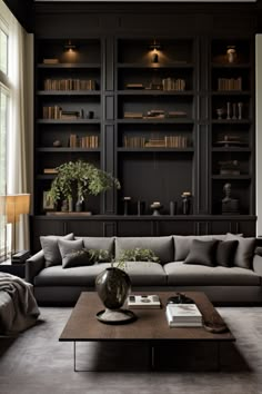 a living room filled with lots of bookshelves next to a couch and coffee table