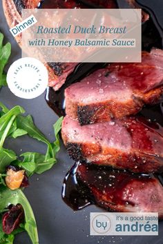 roasted duck breast with honey balsamic sauce on a plate next to greens