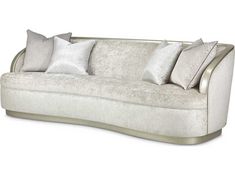 a white couch with silver pillows on it