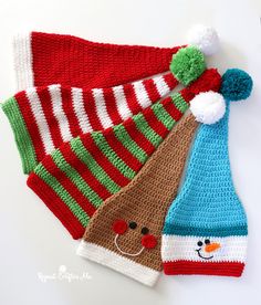 three knitted christmas hats with pom poms