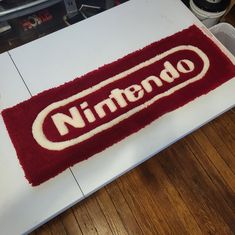 a nintendo logo rug on top of a table