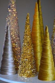 gold and silver cones are lined up on a shelf