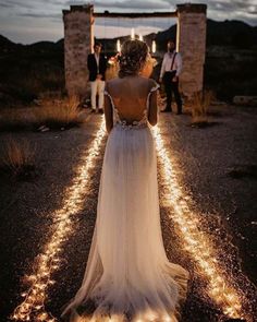 the back of a woman's dress as she stands in front of some people