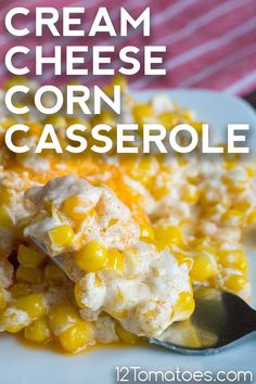 cream cheese corn casserole on a white plate with a spoon