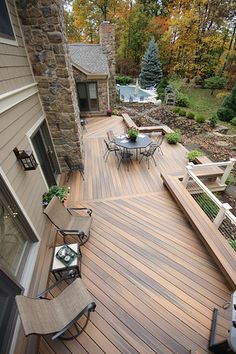 an outdoor deck with chairs and table on it