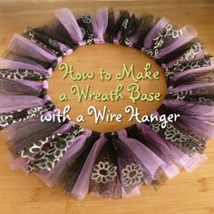 a purple and black tulle wreath sitting on top of a wooden table