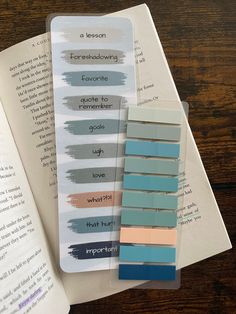 some paint swatches sitting on top of an open book