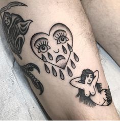 a couple of tattoos that are on someone's leg and one is holding a heart