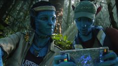 two people with blue paint on their faces and one is holding a cd in his hand