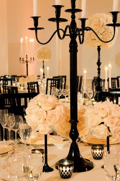 an elegant centerpiece with flowers and candles