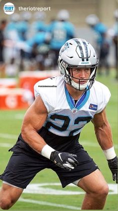 a football player is holding the ball in his hands and ready to run with it