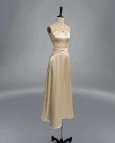 a white dress on a mannequin stand