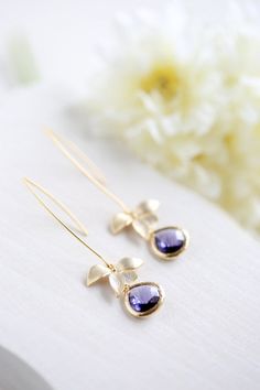 These beautiful long dangle earrings feature delicate matte gold orchids and amethyst purple glass teardrops dangling freely from gold plated long oval hook ear wires. Total length of these earrings is approx. 2.5'' (65mm) including the long oval hook ear wires. ♥ More beautiful modern earrings are available here: www.etsy.com/shop/LeChaim?section_id=17655958 ♥'¨) ¸.*' ¸.**'. (¸.*' (¸.*Thank you for stopping by. Please feel free to contact me if you have any questions or need a different quantit Elegant Purple Teardrop Flower Earrings, Delicate Purple Earrings For Wedding, Delicate Purple Wedding Earrings, Purple Drop Earrings, Gold Orchid, Wedding Purple, Earrings Bridesmaid, Earrings Purple, Long Dangle Earrings