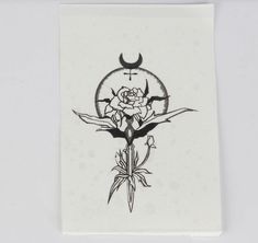 a white paper with a black and white tattoo design on it's back side