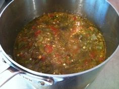 a pot filled with soup sitting on top of a stove