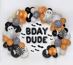 a wreath made out of balloons with the words'bday dude'written on it