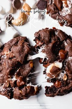 a white plate topped with chocolate cookies and marshmallows next to a fork