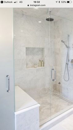 a walk in shower sitting next to a white counter top