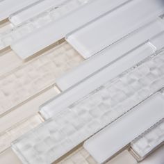 some white glass tiles are lined up together