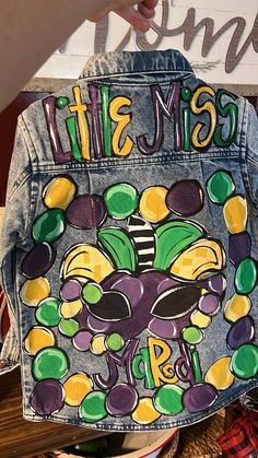 the back of a jean jacket that has been painted