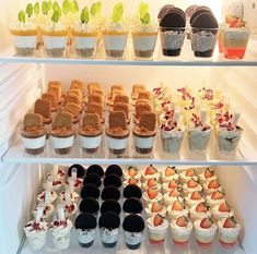 a refrigerator filled with lots of different types of desserts and icecream cups