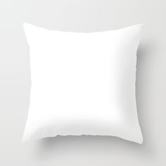 a plain white pillow on a gray background with room for your text or image in the center