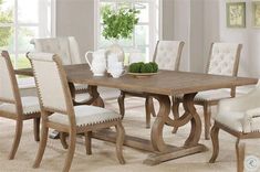 a dining room table with white chairs around it