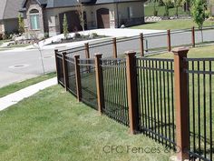 a black iron fence in front of a house