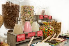 a table filled with lots of different types of candy and candies in glass containers