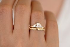 a woman's hand with a yellow and white diamond ring on her left hand