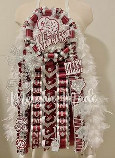 a white and red cheerleader wreath on top of a mannequin