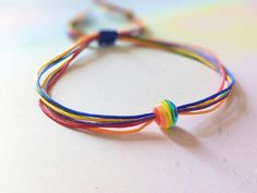 Minimalistic bracelet with rainbow bead and 6 colorful strings. Perfect for the parade, festival or to wear daily (me!) :) Fits wrists for up to 24cm, if you require other size please message me :) Thanks! Rainbow Friendship Bracelets With Sliding Knot, Adjustable Rainbow Friendship Bracelets With Sliding Knot, Adjustable Rainbow Braided Bracelets For Festivals, Adjustable Rainbow Braided Bracelet For Festival, Rainbow Sliding Knot Bracelets For Friendship, Rainbow Adjustable Cord Friendship Bracelet As Gift, Rainbow Sliding Knot Bracelet For Friendship, Rainbow Sliding Knot Friendship Bracelet, Rainbow Adjustable Cord Bracelet As Gift