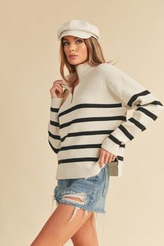 Wrap yourself in luxury with our soft knitted Daffie sweater. Designed with an oversized fit and high collar, this sweater exudes chic comfort. The neck features a trendy zipper, while the long sleeves and dropped shoulder seams add a touch of contemporary flair. Stay cozy and stylish all season long with this must-have wardrobe staple. Fabric Contents: 50% Viscose 28% Polyester 22% Nylon White Jumpsuit Dress, Outerwear Vest, Denim Accessories, Sweater Dress Midi, Cardigan Top, Zip Sweater, White Sweaters, High Collar, Stripe Sweater