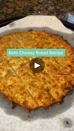 the keto cheesy bread recipe is displayed on a paper plate with a video play button