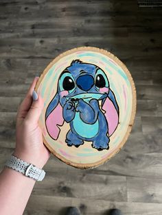 a person holding up a painted plate with stitchy stitch stitch stitch stitch stitch stitch stitch stitch