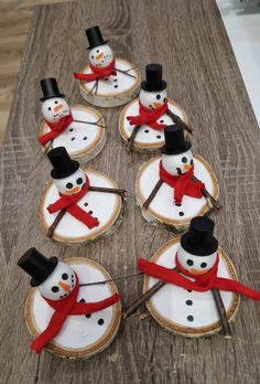 these snowmen are made out of wood slices