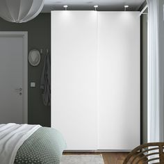 a bedroom with a bed and white closet doors