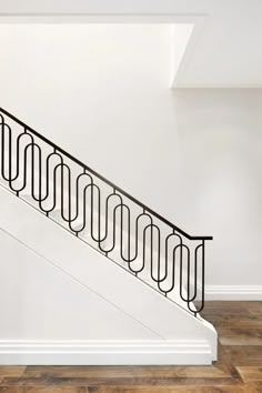 a stair case on the side of a white wall