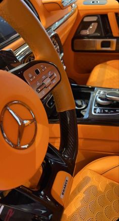 the interior of a car with orange leather and steering wheel