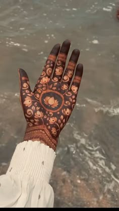 a person's hand with henna tattoos on it