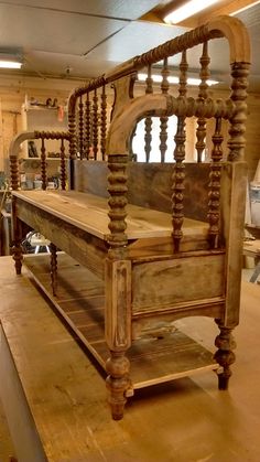 an old wooden bed frame in a room