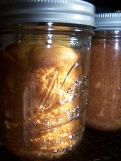 two jars filled with food sitting on top of a shelf