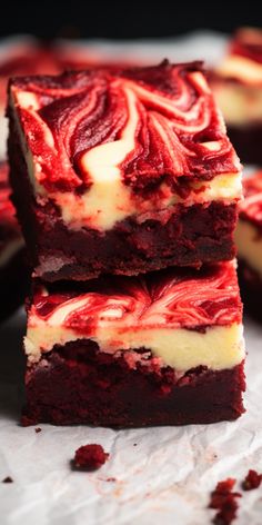 red velvet cheesecake brownies stacked on top of each other