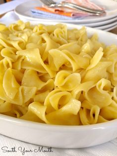 a white bowl filled with pasta on top of a table