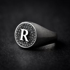 A handmade sterling silver 925 round letter signet ring set with black zircons.Each ring is cleaned and polished with care.The weight of the ring may vary according to size.Aprrox weight: 4.52grRing Hight: 13mmThe ring is made of sterling silver 925 and is water resistant.The ring is set with black zircons and can be made with any letter from A-Z.If you have any further questions, please don’t hesitate to contact us.Back to the store >>> https://www.etsy.com/il-en/shop/NADesignsStoreMak Luxury Silver Signet Ring With Monogram, Luxury Silver Monogram Signet Ring, Luxury Silver Signet Ring With Initials, Silver Monogram Signet Ring, Luxury Silver Monogram Initial Ring, Luxury Silver Initial Ring With Monogram, Black Personalized Sterling Silver Signet Ring, Signet Ring Silver, Silver Initial Ring