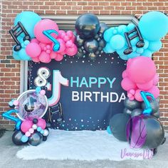 a birthday decoration with balloons and streamers on the front door for a child's first birthday