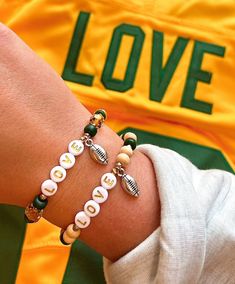 Dive into the spirit of Green Bay with our 'Gridiron Glory' bracelet collection, celebrating the rich history of the Packers. Each bracelet in this collection is a tribute to the legendary team, with variations that capture the essence of their iconic green and gold. Whether you're at Lambeau Field or cheering from afar, these bracelets are a stylish way to showcase your Packers pride. 'Gridiron Glory' isn't just a collection; it's a wearable piece of history for the true Packers fan. Personaliz Lambeau Field, Packers Football, Packers Fan, Bracelet Collection, Custom Bracelets, Green Bay, Green And Gold, Round Beads, Jewelry Bracelets