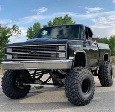 a large black truck parked on top of a parking lot