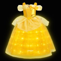 a yellow dress with lights on it and a bow at the neckline is shown