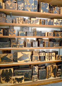 several wooden boxes are stacked on shelves in a room